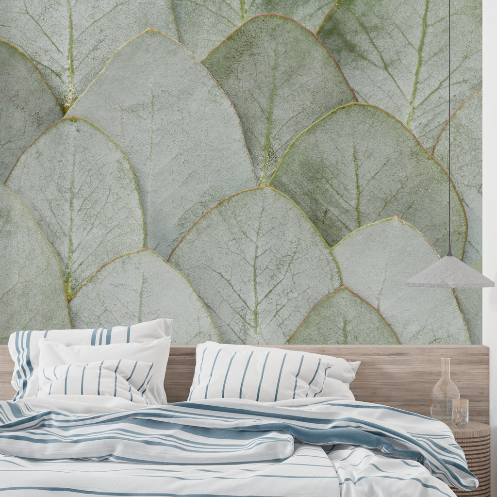 Green leaf mural creating a natural focal point in a minimalist bedroom
