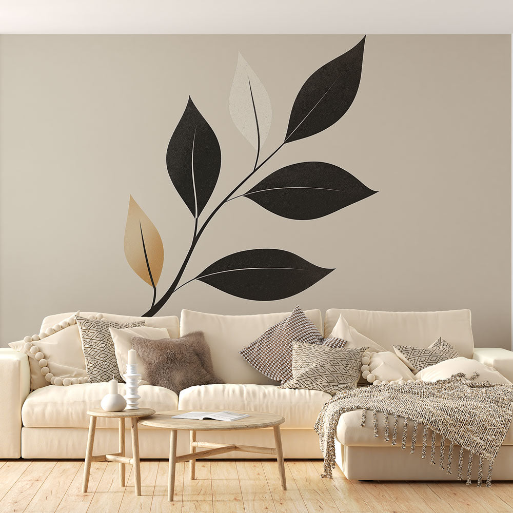 Modern black and gold botanical wallpaper creating a luxurious statement wall in a minimalist living room setting