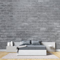 Grey brick wallpaper in modern minimalist living room with leather sofa and industrial lighting