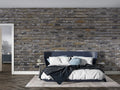 Industrial grey brick wallpaper in modern living room with leather sofa and metal accents