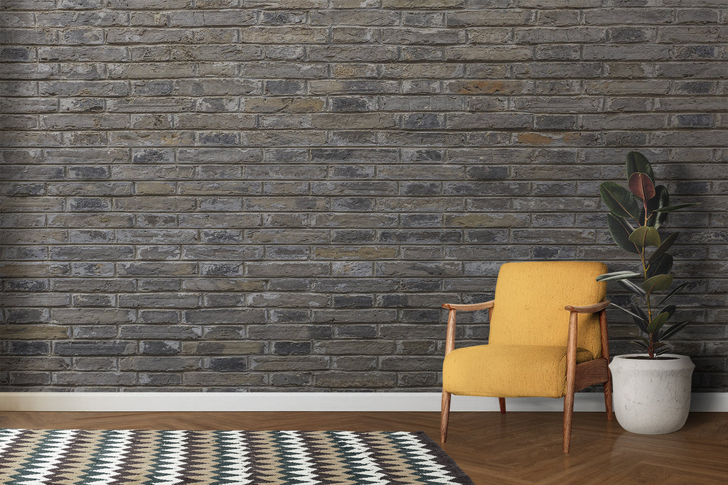 Grey brick wall mural in industrial kitchen with stainless steel appliances