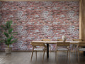 Red brick wallpaper mural creating an industrial accent wall in a modern living room with leather furniture