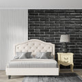 Black brick wallpaper in modern living room with grey sofa and industrial lighting
