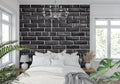 Modern black brick wallpaper in contemporary living room showing textured industrial design and natural lighting effects