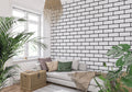 Modern black and white brick wallpaper in a bright contemporary living room with minimalist furniture