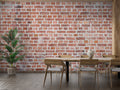 Vintage brick wallpaper creating an industrial feel in a modern living room with leather sofa