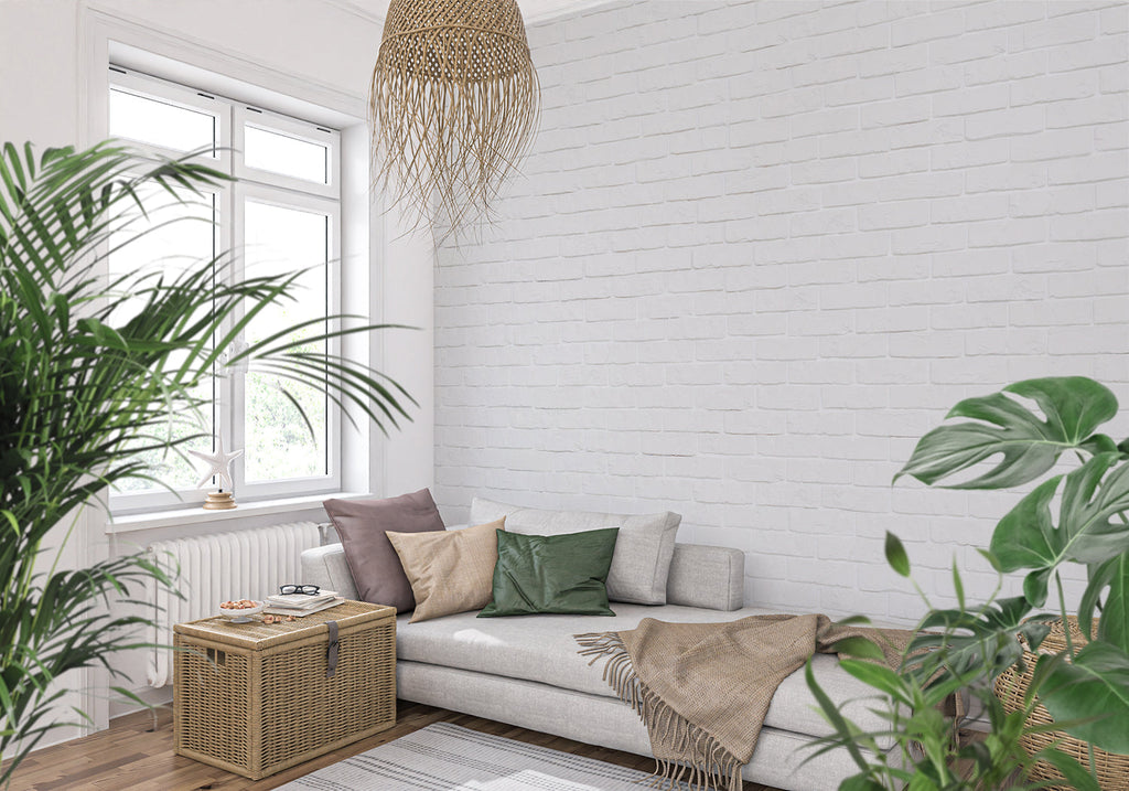 White brick wallpaper in modern living room with grey sofa and natural light
