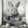 Black and white bunny wallpaper in modern nursery with white furniture