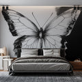 Black and white butterfly wall mural creating dramatic impact in a modern living room with minimalist furniture