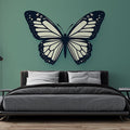 Black and white butterfly wall mural creating modern contrast in a bright living room with minimal furniture
