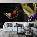 Butterfly wall mural creating a magical focal point in a modern living room, purple and orange tones adding warmth
