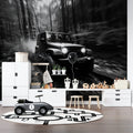 Black and white car wallpaper creating drama in modern living room with grey sofa and minimal decor