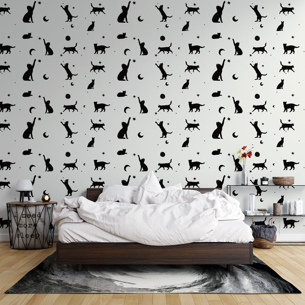 Modern living room with black cat silhouette wallpaper showing cats and moons pattern creating a cozy atmosphere