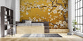 Cherry blossom wallpaper with gold accents in modern living room creating zen atmosphere