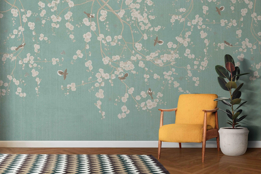Cherry blossom wallpaper with birds shown in a bright living room, mint green walls creating a fresh spring atmosphere