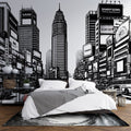 Black and white comic style city mural wallpaper in modern minimalist living room, creating dramatic urban atmosphere