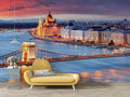 Budapest cityscape mural wallpaper in modern living room, showing warm sunset colors over the Danube