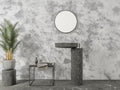 Modern concrete effect wallpaper in a minimalist living room with grey sofa and natural light