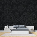 Black and silver baroque wallpaper in modern dining room with crystal chandelier