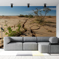 Desert landscape wallpaper creating a stunning focal point in a modern living room with earth tones and natural light