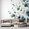 Eucalyptus botanical wallpaper creating a serene atmosphere in a modern living room with natural light and minimal furniture