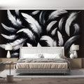 Black and white feather wallpaper mural in modern minimalist bedroom, creating an elegant floating effect above the bed