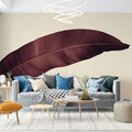 Burgundy feather wallpaper mural creating a stunning accent wall in a modern living room with beige furniture