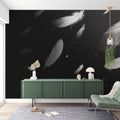 Black and white feather wallpaper mural styled in a modern bedroom with minimal furniture and natural light