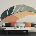 Modern feather wallpaper in terracotta and green tones creating a calm atmosphere in a minimalist living room