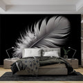 Black and white feather wallpaper creates dramatic contrast in a minimal living room setting