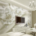 White 3D floral wallpaper creating depth in a modern living room with natural light highlighting the textured blooms
