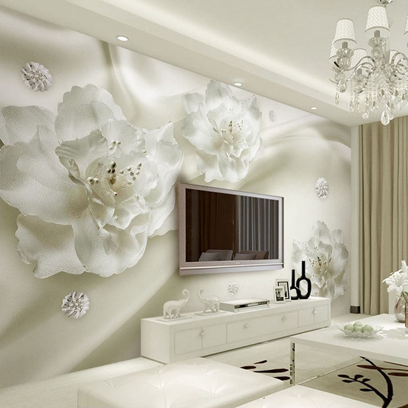 White 3D floral wallpaper creating depth in a modern living room with natural light highlighting the textured blooms