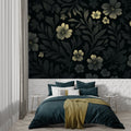 Black and gold floral wallpaper creating drama in a modern dining room with pendant lights
