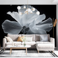 Black and white floral wallpaper mural creating dramatic contrast in a modern living room with minimal furniture