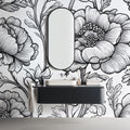Black and white botanical line art mural wallpaper styled in a modern dining room with minimal furniture
