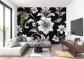 Black and white floral wallpaper in modern living room setting with minimal furniture