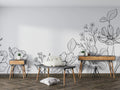 Modern black and white botanical line art wallpaper creating a sophisticated backdrop in a minimalist living room