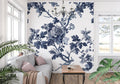 Blue Toile de Jouy wallpaper in an elegant dining room with white wainscoting and crystal chandelier
