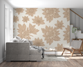 Large beige floral wallpaper mural in modern living room with gray sofa and natural light
