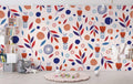 Modern Scandinavian floral wallpaper in bright living room, navy and orange pattern adding warmth to white walls