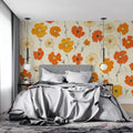 Orange and cream cosmos floral wallpaper in bright modern living room setting with natural light