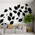 Black and white leaf mural wallpaper in a modern living room creating dramatic contrast against furniture