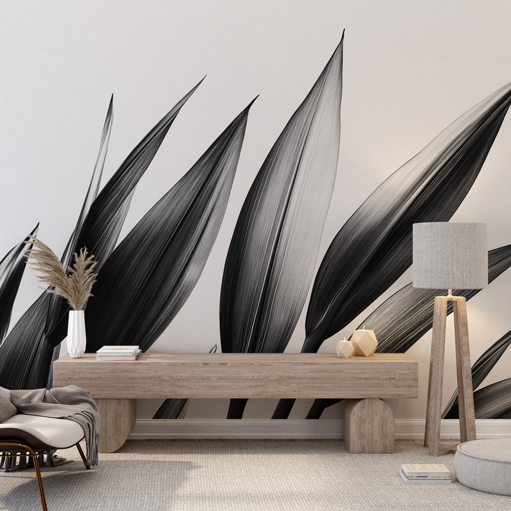 Black and white leaf wallpaper creating a stunning focal point in a modern minimalist living room with natural light