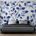 Blue botanical wallpaper mural bringing fresh style to a modern living room with white furniture and natural light