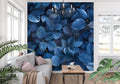 Blue leaf wallpaper mural creating depth in a modern living room with grey sofa and natural light