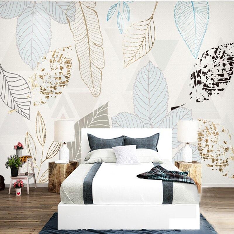 Botanical gold leaf wallpaper adding sophistication to a master bedroom with natural light