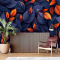 Navy blue and orange leaf wallpaper in modern living room with grey sofa and natural light