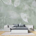 Botanical wallpaper in modern living room showing sage green leaf pattern creating depth