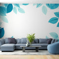 Blue leaf wallpaper mural creating a fresh atmosphere in a modern living room with natural light