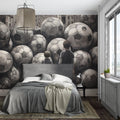Soccer ball wallpaper bringing modern style to a teen bedroom with black and white optical illusion design